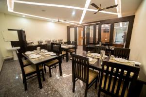 a dining room with tables and chairs in a restaurant at TTK Residency in Āndippatti