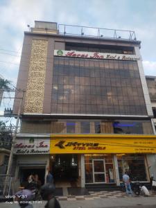 a building with a yellow sign on the front of it at Hotel Aavas Inn in Tezpur