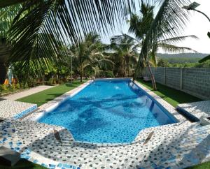 a swimming pool with two lounge chairs and a resort at Phu Nam House - Resort in Phú Quốc
