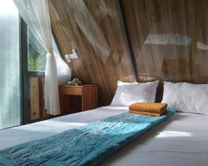 a bedroom with a bed with a wooden wall at Phu Nam House - Resort in Phú Quốc +37 photos