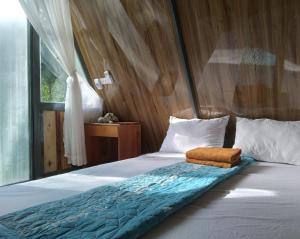 1 dormitorio con 1 cama con pared de madera en Phu Nam House - Resort en Phu Quoc