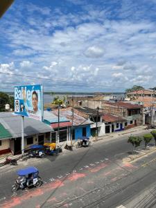 a city street with buildings and a large billboard at Alojamiento Tahuari - Iquitos- Perú in Iquitos
