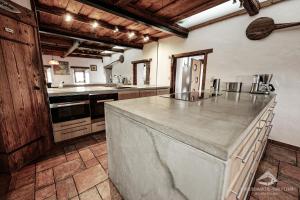 a large kitchen with a large island in the middle at Schmolti's Chalet - Wellness über Graz in Zösenberg