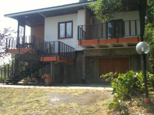 a house with stairs and balconies on it at Agriturismo La Fornace di Poggiano in Montepulciano