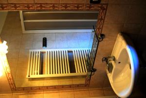 a mirror in a bathroom with a radiator at Agriturismo La Fornace di Poggiano in Montepulciano