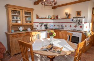 a kitchen with a wooden table and a table and chairs at Troadkasten - Ferienhaus am BIO-Bergbauernhof in Aflenz Kurort
