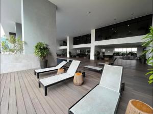 a lobby with benches and plants in a building at KL Sentral Serviced Apartment - The Establishment KL Sentral by Loop Suites in Kuala Lumpur