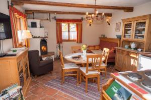 a kitchen and living room with a table and chairs at Troadkasten - Ferienhaus am BIO-Bergbauernhof in Aflenz Kurort