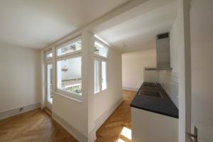 an empty kitchen with a sink and a window at City Center Apartment in Interlaken
