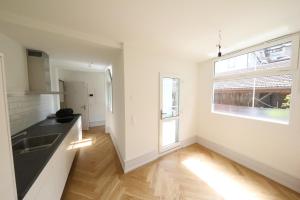 an empty kitchen with a sink and a window at City Center Apartment in Interlaken