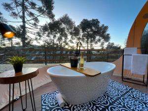 a bath tub sitting on top of a patio at Zion Bubble Glamping in Urubici