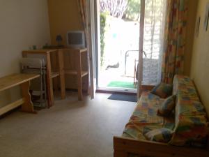 a living room with a couch and a sliding glass door at Studio Pirineo Frances in Luz-Saint-Sauveur