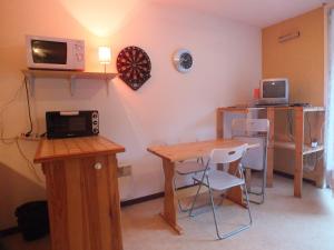 a room with a table and a dart board on the wall at Studio Pirineo Frances in Luz-Saint-Sauveur