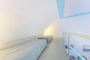 A bed or beds in a room at Palazzo Attila - Gioia Apartments