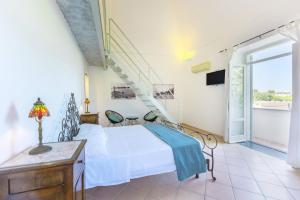 A bed or beds in a room at Palazzo Attila - Gioia Apartments