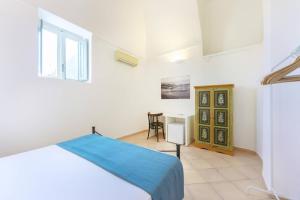 A bed or beds in a room at Palazzo Attila - Gioia Apartments