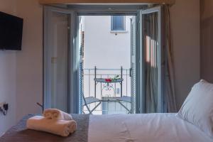 a room with a bed with a towel on it at OLYMPIA ROOMS in Myrina