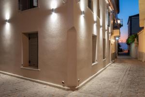 an empty street in an alley at night at OLYMPIA ROOMS in Myrina