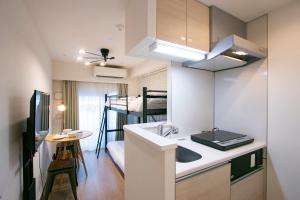 a small kitchen with a sink and a bunk bed at KARIO Sasazuka in Tokyo