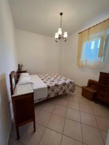1 dormitorio con 1 cama y 1 silla en Casa Vacanze Fraiese Vincenzo, en Paestum