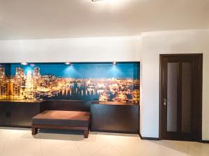 a room with a wall mural of a city at Cozy apartments on the Left Bank in Kyiv