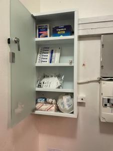 a cupboard with some food inside of it at Bel appartement composé de deux chambres in Saint Etienne