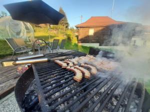 a grill with a bunch of hot dogs on it at Coliba la Valle in Petroşani