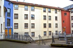 a row of colorful buildings in a city at Darroch Court - Self Catering Flats in Edinburgh