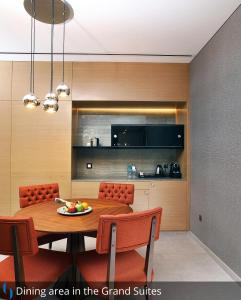a dining area in a kitchen with a table and chairs at Grand Cosmopolitan Hotel in Dubai