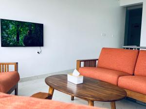 a living room with a couch and a table at M town Homestay in Kodaikānāl