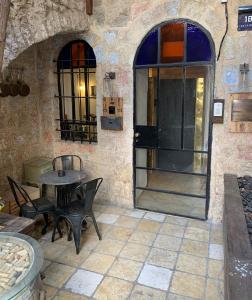 a patio with a table and chairs and a door at Private Room Studio Suite Jerusalem in Jerusalem