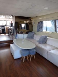 a living room with a white couch and a table at Un yacht de 24m rien que pour vous ! in Sète