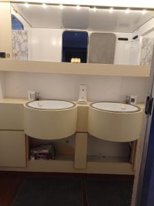 a bathroom with two sinks and a mirror at Un yacht de 24m rien que pour vous ! in Sète