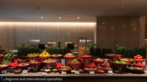 a buffet filled with lots of different types of food at Grand Cosmopolitan Hotel in Dubai