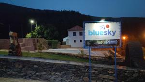 a billboard sign in front of a building at night at BLUESKY by Camelo Casas de Campo in Camelo