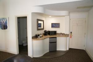 a kitchen with a counter and a toilet in a room at Spokane Club Hotel in Spokane