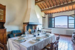 a dining room with a table and a fireplace at Casale Giglio in Pergine Valdarno