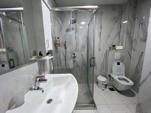 a bathroom with a sink and a shower and a toilet at Apartman Ano LUX in Novi Pazar +13 photos