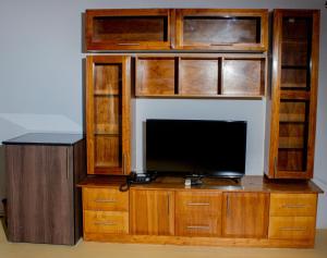 a entertainment center with a tv on top of it at Wild View Resort in Kasane