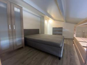 a small bedroom with a bed and a closet at Ferret vacances in Lège-Cap-Ferret +10 photos