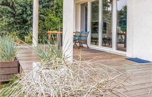 a porch of a house with chairs and plants at Beautiful Home In Nowe Warpno With Wifi in Nowe Warpno