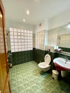 a bathroom with a toilet and a sink at Hotel The Golden fish in Sozopol