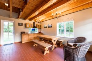 a dining room with a wooden table and chairs at Holmiranna Holiday Homes in Kungla
