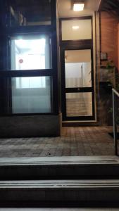 an open door of a building with a brick sidewalk at Mamuccia Rooms Posto Auto in Naples