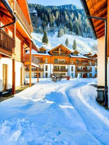 a snow covered street in front of a lodge at Modern Mountain Apart 2 - directly by Skiing area in Rauris