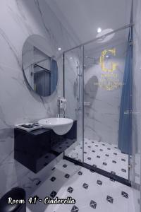 a bathroom with a sink and a shower with a mirror at Galaxy Hotel 2 in Ho Chi Minh City