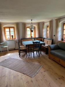 a living room with a table and chairs and a couch at Ferienhaus Klause in Neureichenau