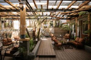 a patio with chairs and tables in a building at Dalat Family Hostel in Da Lat