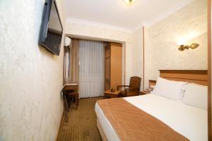 Télévision ou salle de divertissement dans l'établissement Grand Unal Hotel