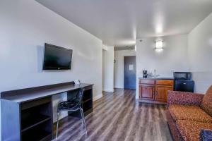 a living room with a couch and a flat screen tv at Motel 6-Hesperia, CA - West Main Street I-15 in Hesperia +20 photos